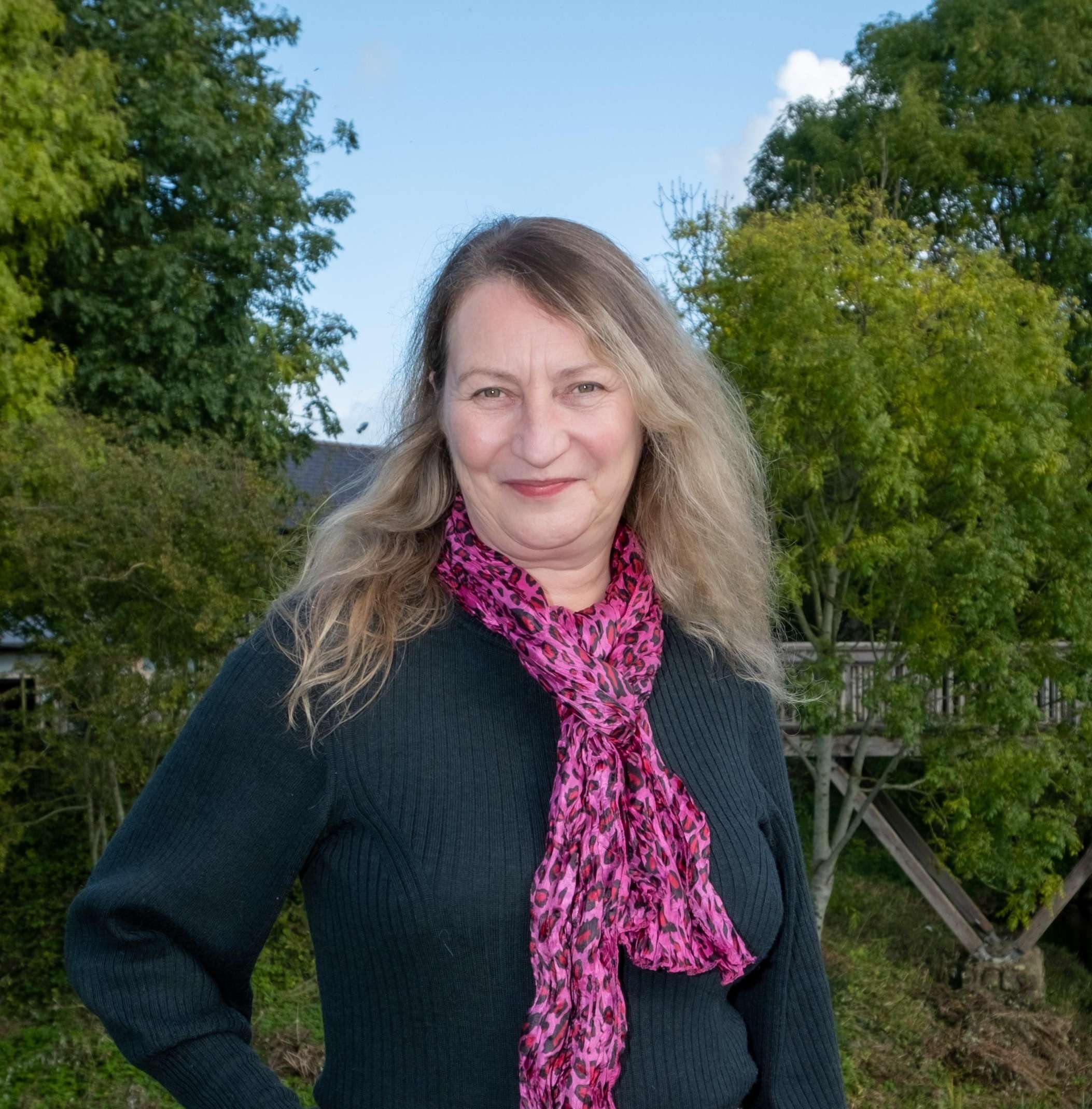 Jenny holding money, british pounds in a garden